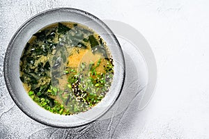 Japanese miso soup in a white bowl. White background. Top view. Copy space