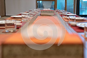 Japanese modern applied dining room style with eastern dish, fork, spoon, napkin and glass on the table