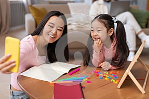Japanese Mom Making Selfie Teaching Daughter To Read At Home