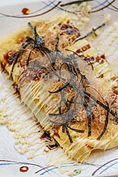 Japanese Omlette Topping with Sauce, Mayonaise, Katsuobushi dried, fermented, and smoked skipjack tuna and Seaweed