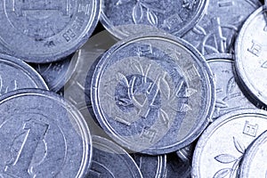 Japanese one yen coins on a black background