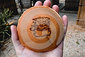 Japanese pancake snack with a symbol of mythical Okinawa dog Shisa