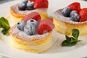 Japanese pancakes are fluffy, souffle-like pancakes that are airy perfection when topped with powdered sugar, blueberry and