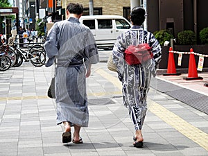 Japanese people couple lovers wearing traditional japan clothes yukata walking go to travel visit and respect praying god deity