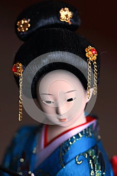 Japanese porcelain doll in blue kimono