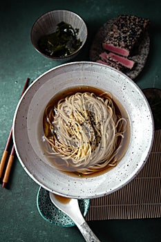 Japanese ramen. Asian soup with noodles ramen, miso, fried tuna steak and seaweed algae