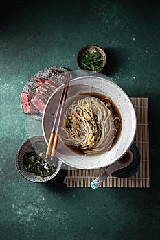 Japanese ramen. Asian soup with noodles ramen, miso, fried tuna steak and seaweed algae