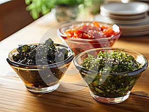 Japanese raw vegan organic delicious and tasty marinated chuka wakame salad and seaweed nori salad dishes in glass bowls