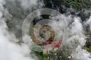 The Japanese red Inari in the midst of steam with Umi Jigoku PondBlue sea water Hell is one of eight Beppu hot spring onsen.