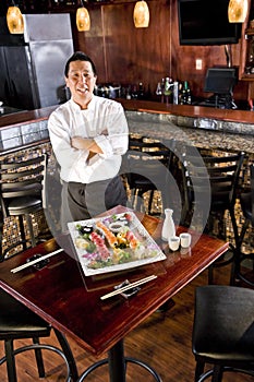 Japanese restaurant chef presenting sushi platter