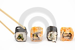 Japanese restaurant food. hand pick sushi roll with chopsticks on white isolated background.