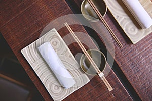 Japanese restaurant in traditional style, Empty plate on mat near chopstick bowl, Selective Focus