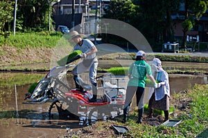 Japanese rice farmer loading his rice planting mac