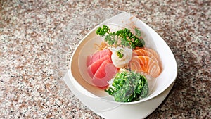 Japanese rice with mix sashimi don in a white bowl