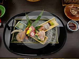 Japanese ryokan kaiseki dinner decorative sashimi set including Pacific blue fin tuna, shrimp, greater amberjack, halfbeak