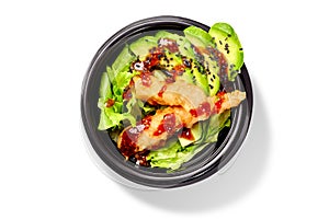 Japanese salad with lettuce, avocado and shrimps tempura dressed with mirin sauce and black sesame