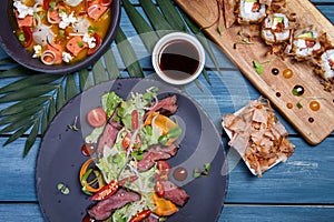 Japanese salad with meat, chili pepper, cherry tomatoes and fresh sprouts