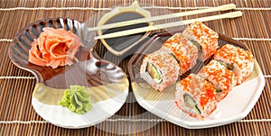 Japanese seafood sushi rolls with chopstick wasabi