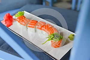 Japanese seafood sushi set on dark background served in a white round plate. Traditional Japanese cuisine concept