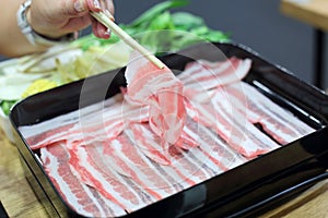 Japanese shabu hot pot style with chopstick and woman hand