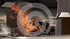 Japanese shinto priests burning sacred items.