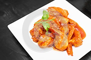 Japanese Shrimp in Chili Sauce or ebichiri serving on white plate. Chinese-Japanese dish features sweet and silky shrimp in chili