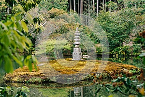 Japanese stone lantern standing in pond