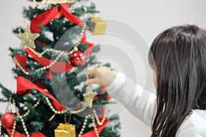 Japanese student girl decorating Christmas tree