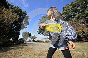 Japanese student girl playing flying disc