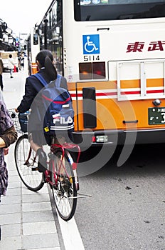 Japanese student girl riding bicycle go back home after finished