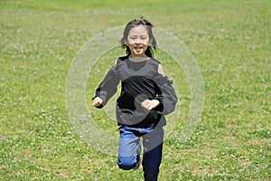 Japanese student girl running on the grass