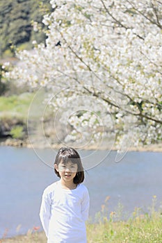 Japanese student girl standing on riverside