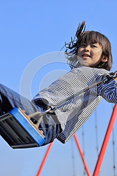 Japanese student girl on the swing