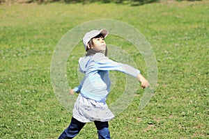 Japanese student girl throwing a ball