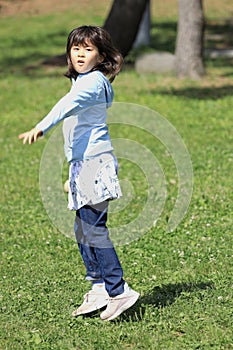 Japanese student girl throwing a ball