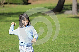 Japanese student girl throwing a ball