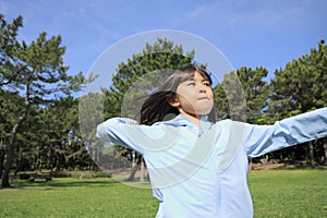 Japanese student girl throwing a ball