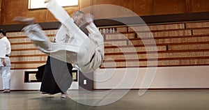 Japanese students, throw or sensei in dojo to start practice lesson, discipline or teaching self defense. Black belt