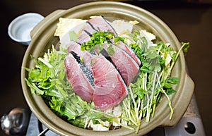 Japanese style hot pot with raw fish and vegetabels in ceramic pot