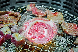 Japanese style Raw fresh beef on hot barbecue grill .