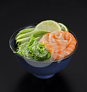 Japanese style seaweed salad with salmon, avocado and lime