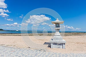 Japanese style stone lamp in white sand beach in Aoshima island, Miyazaki, Japan