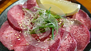 Japanese style yakiniku thin slices beef tongue gyutan bbq roast with lemon green onion sesame