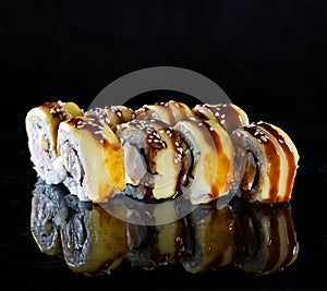 Japanese Sushi  on black background. Reflection in a mirror surface. Close up. Studio photo