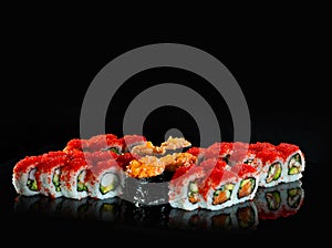 Japanese Sushi  on black background. Reflection in a mirror surface. Close up. Studio photo