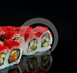 Japanese Sushi  on black background. Reflection in a mirror surface. Close up. Studio photo