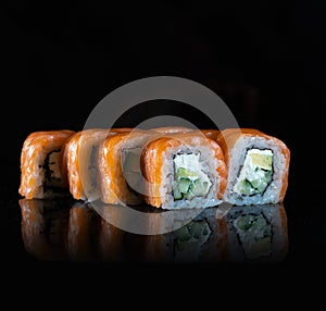 Japanese Sushi isolated on black background. Reflection in a mirror surface. Close up. Studio photo