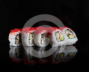 Japanese Sushi isolated on black background. Reflection in a mirror surface. Close up. Studio photo