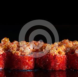 Japanese Sushi isolated on black background. Reflection in a mirror surface. Close up. Studio photo