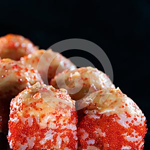 Japanese Sushi isolated on black background. Reflection in a mirror surface. Close up. Studio photo